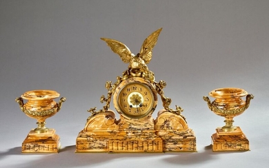 Empire style mantel set in yellow Sienna marble and gilded bronze comprising a clock with an eagle with outstretched wings and a pair of cassolettes.