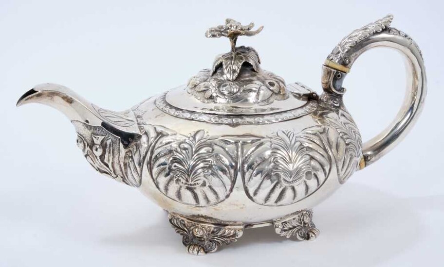 George IV silver teapot of compressed melon form, with panels of foliate decoration