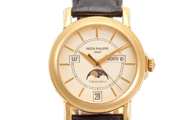PATEK PHILIPPE. AN 18K GOLD AUTOMATIC ANNUAL CALENDAR WRISTWATCH WITH...
