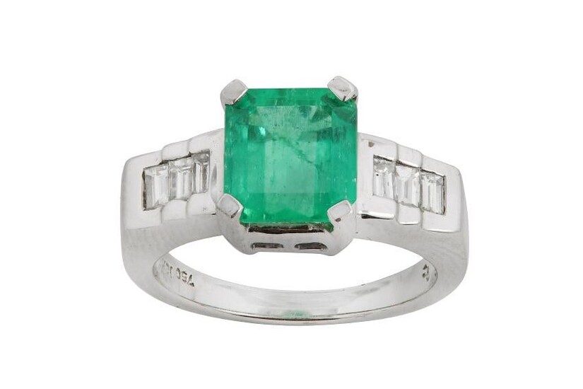 An emerald and diamond ring