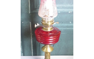 20th century brass oil lamp, with red glass reservoir and cr...