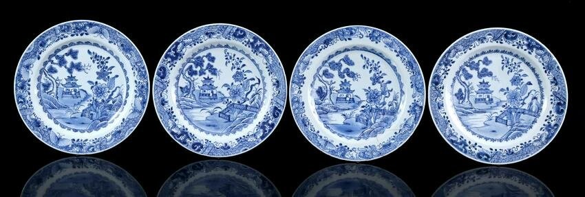 4 porcelain dishes with blue decor of a temple in a