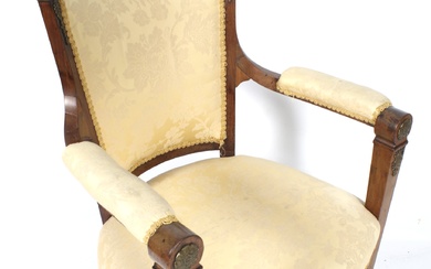 A 19th century French empire library style open armchair.