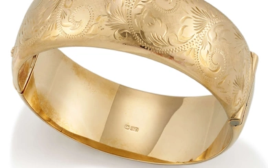 A 9ct gold bangle, of broad hinged design, the front...