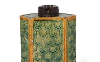 A Chinese biscuit porcelain green and yellow-enamelled tea caddy, Kangxi period, the exterior decorated with an incised honeycomb design, with pierced wood cover, 13cm high 清康熙 素燒茶葉罐