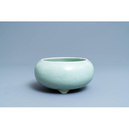 A Chinese celadon-glazed tripod censer with incised undergla...