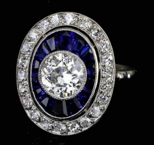 A Diamond and Sapphire Halo Ring, Modern, in 18ct...