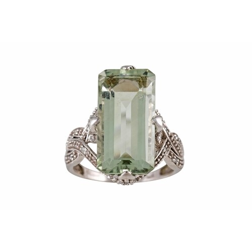A GREEN QUARTZ AND DIAMOND DRESS RING, mounted in 9ct gold