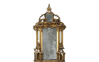 A George III gilt gesso and carved wood wall mirror. In the ...
