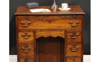 A George III mahogany kneehole desk, the ovolu moulded top a...
