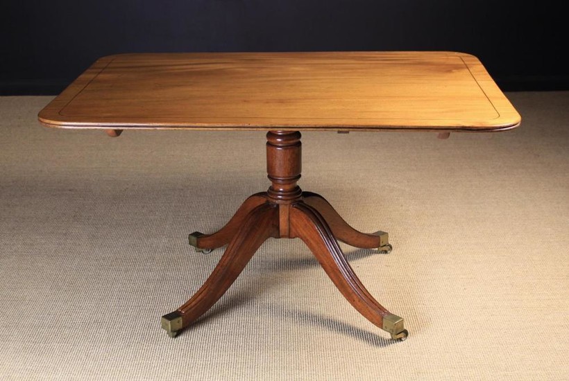 A Good, Regency Mahogany Tilt-top Breakfast Table. The rectangular top with rounded corners, mellow