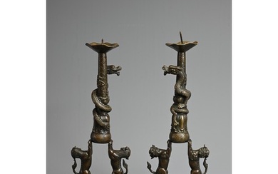 A PAIR OF CHINESE BRONZE PRICKET CANDLESTICKS. With figures ...