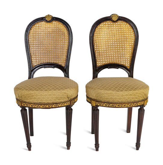 A Pair of Black Painted, Caned and Upholstered Side Chairs Height 37 x width 18 x depth 17 inches.