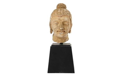 A STUCCO BUDDHA HEAD WITH RED PIGMENT RESIDUES Gandhara or Fondukistan, Afghanistan, 3rd - 5th century