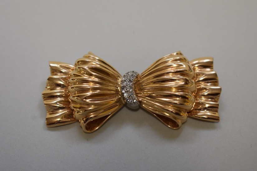 A Tiffany & Co gold and diamond set bow brooch, stamped ...