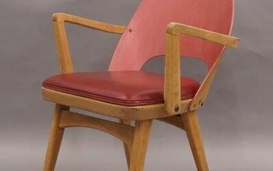 A bent ply and beech armchair, circa 1950, The red stained back rest above red leather upholstered seat on tapered supports, together with a library trolley with opposing sets of 3 shelves on casters, 101cm high, 92cm wide, 56cm deep. (2)