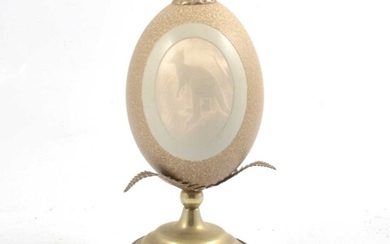 A carved and mounted ostrich egg.