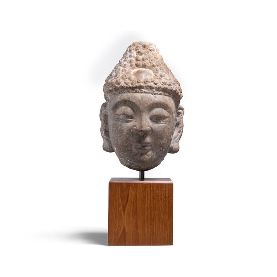A carved limestone head of the Buddha