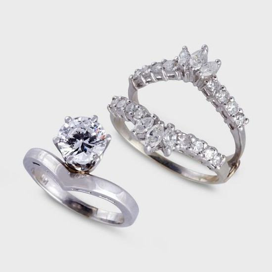 A diamond and fourteen karat white gold ring with an