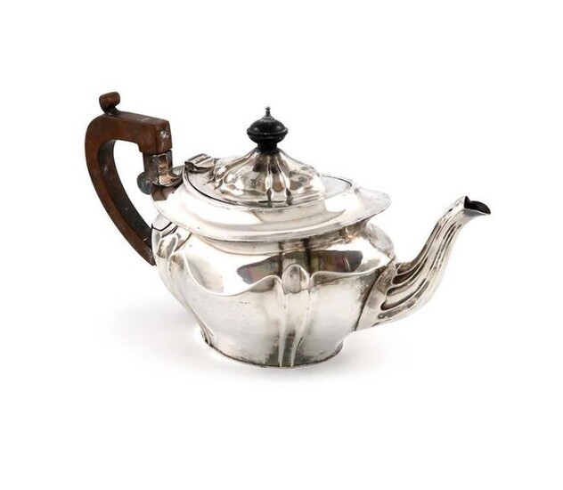A late-Victorian silver teapot, by Robert Pringle, London 1900, lobed oval form, scroll handle, domed hinged cover, length handle to spout 29.3cm, approx. weight 20oz.