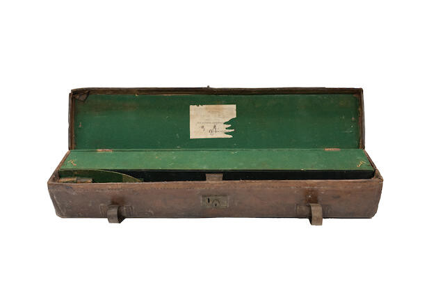 A leather guncase and a brass-mounted leather cartridge magazine