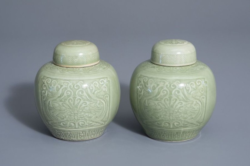 A pair of Chinese celadon jars and covers...