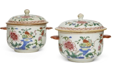 A pair of Chinese famille rose twin-handled circular bowls and covers, 18th century, raised on a short foot with deep rounded sides, painted to the exterior with peonies and fruits, flanked by a pair of shell shape handles painted in iron red, the...