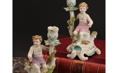 A pair of Continental porcelain figural candlesticks, probab...