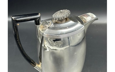A silver coffee pot with ebonised handle and finial, approxi...