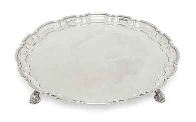 A silver salver with Chippendale style border, Birmingham, 1940, William Suckling, raised on four scroll feet, 26.7cm dia., approx. weight 18.7oz