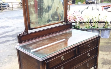 A stained mahogany dressing table with carved pierced spandrels, the...