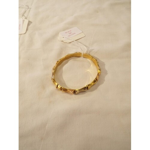 An 18ct gold bangle in the form of bamboo 17.2g