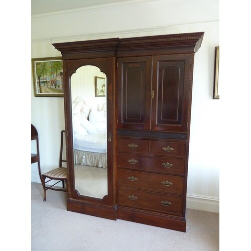 An Edwardian mahogany compactum wardrobe, breaks down in to...
