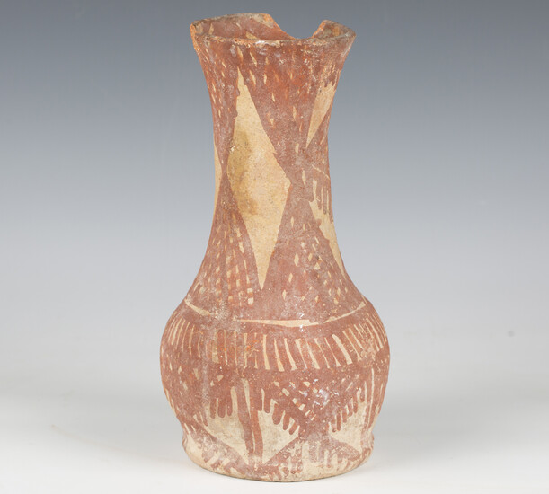 An ancient pottery vase, possibly Mesopotamian, the exterior and rim interior painted with red linea