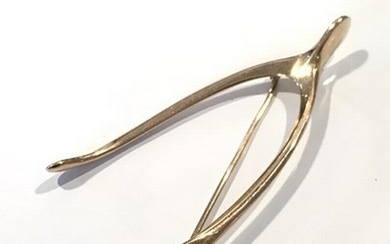 An early 20th century gold wishbone brooch, apparently unmar...