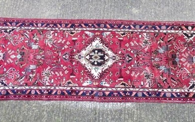 Carpet / Rug : A Persian Hamadan runner, the red ground with central cream ground medallion with