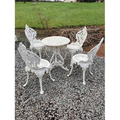 Cast iron garden table and four cast aluminium garden chairs...