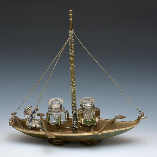 Inkwell set in figural brass boat with painted sailor