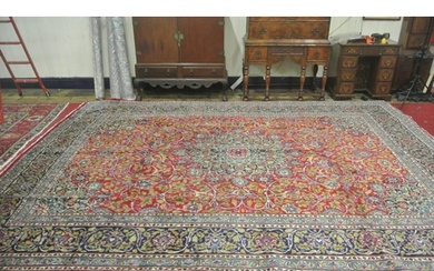 Large red ground Persian Kashan carpet with Lozengier Medall...