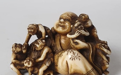 Netsuke - Elephant ivory - God of Good Fortune Hotei with his bag of riches and small oni - With signature Shinrissai 新立斎 ? - Japan - Meiji period (1868-1912)