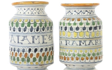 Pair of Albarelli Wohl Portugal, 19th century, reddish majolica shards, white tin glaze all around, various coloured scales and inscriptions ''AM RAMARRO SY (?)'' resp. ''AMIGD PALAMEN (?)'' in the middle of the body, round stand with waisted shaft...