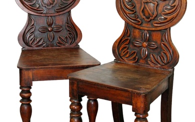 Pair of French hall chairs in walnut with shaped backs