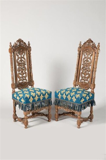 Pair of high back walnut Chairs with moulded, carved and openwork backrest, H-shaped spacer base. Small fleur-de-lys stitch upholstery. Louis XIII style, 19th century period. H. 126 cm.