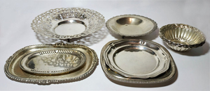 collection of silver plates and bowls