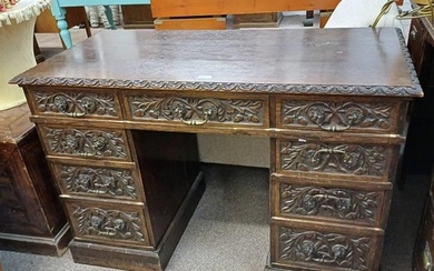 19TH CENTURY CARVED OAK KNEEHOLE DESK WITH CENTRALLY SET SIN...