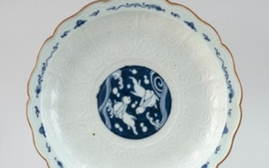 BLUE AND WHITE ARITA PORCELAIN CHARGER In flower form. With rabbit center surrounded by relief butterflies and blue dragons. Pearl b...