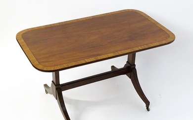 A 19thC mahogany table with a satinwood crossbanded top abov...