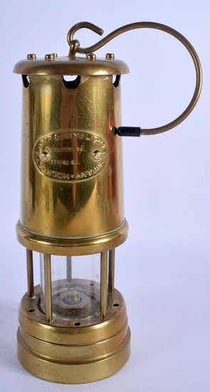A BRASS MINERS LAMP. 31 cm high.