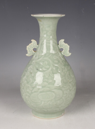 A Chinese celadon glazed porcelain vase, late Qing dynasty, the baluster body decorated in low relie