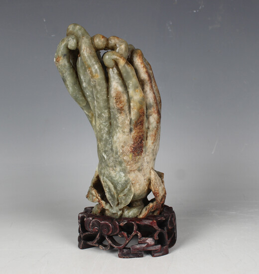 A Chinese green hardstone carving, 20th century, modelled as a Buddha's hand citron with carved